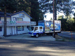 A truck parked in front of a store.