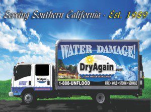 A water damage truck is parked in front of the sky.